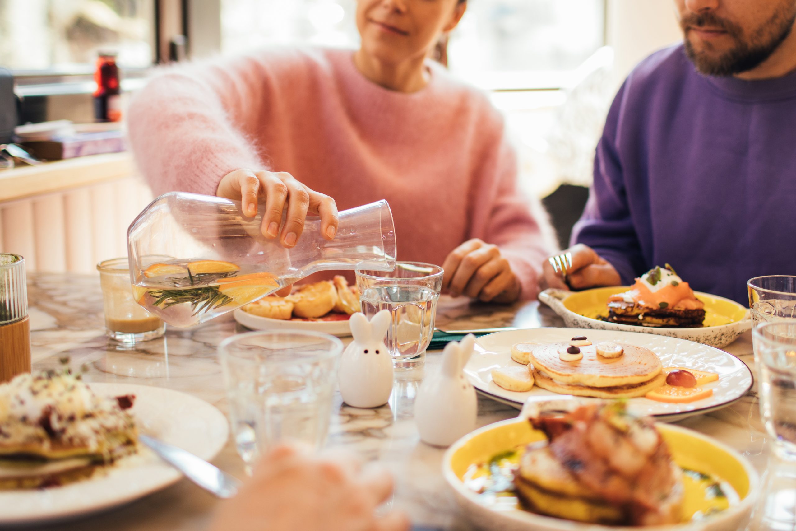 Group of millennial friends having breakfast together in a coffeeshop